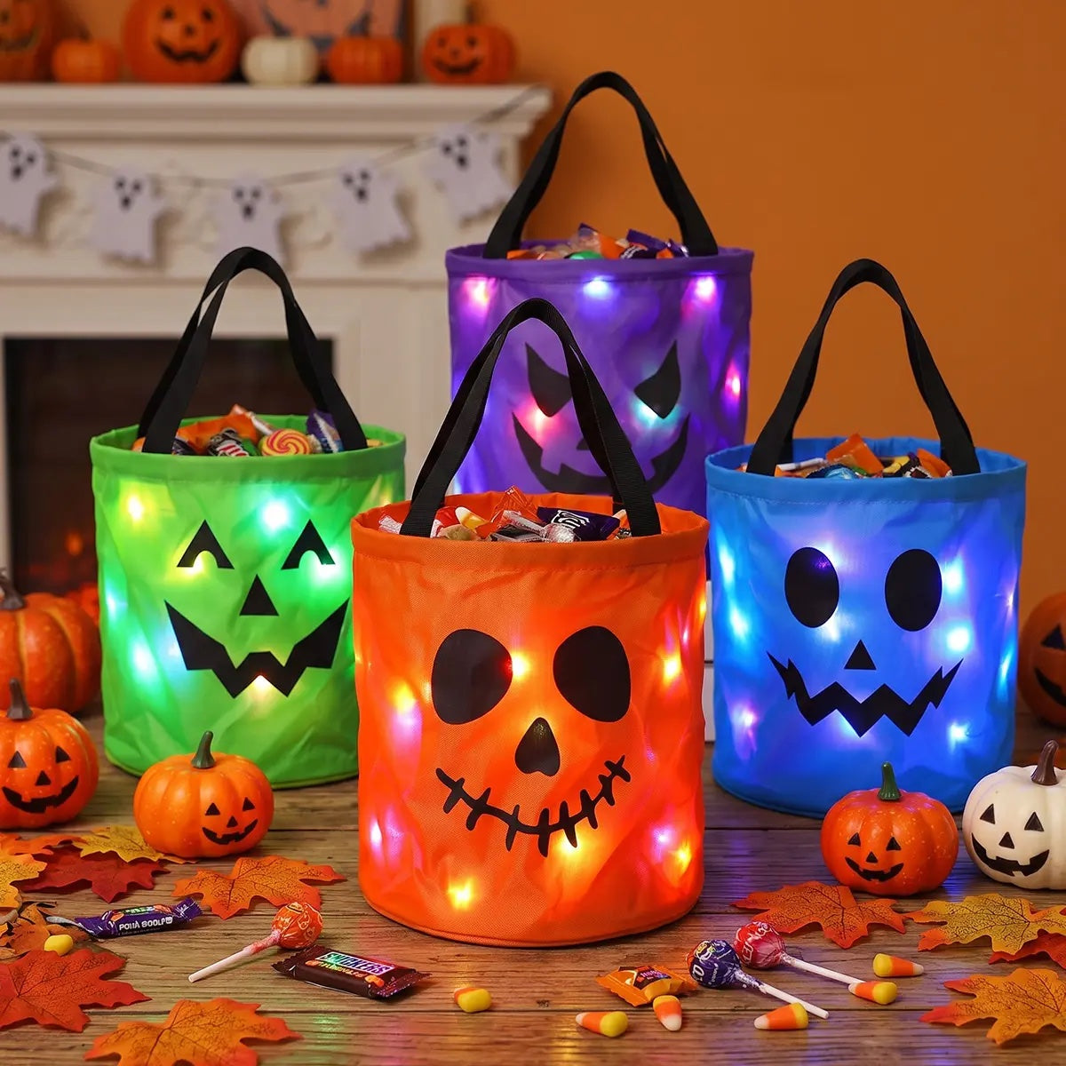 Four reusable LED Halloween totes glowing on a table